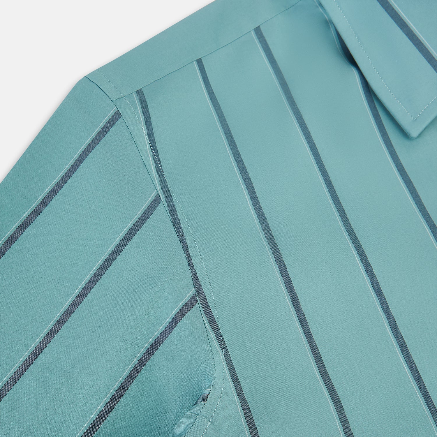 Image 6 of product The Turnbull & Asser Sage Track Stripe Westminster Shirt features long sleeves, a tailored fit, a collar, and vertical dark blue stripes, with button closures down the front and at the cuffs, shown laid flat on a white background.
