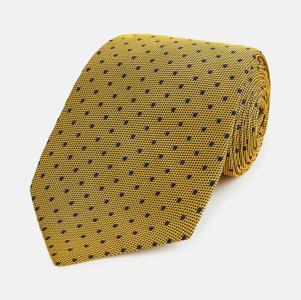 The Turnbull & Asser Purple and Yellow Micro Dot Silk Tie, featuring a refined micro-dot pattern, is a timeless men's accessory.