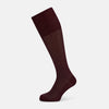 View 1 of product The Turnbull & Asser Burgundy Motif Long Sock, made from mercerised Egyptian cotton with a subtle diamond motif, is shown knee-high on a plain white background.