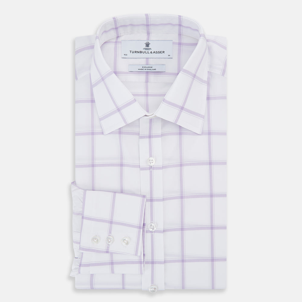 The Turnbull & Asser Lilac Grid Check Mayfair Shirt is a long-sleeve, button-up style crafted from Italian cotton with a white base and lilac grid check pattern, shown on a plain white background.