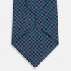View 3 of product The Turnbull & Asser Navy and Red Rosette Silk Tie features a small repeating red and light blue geometric pattern on white, crafted from fine English silk.