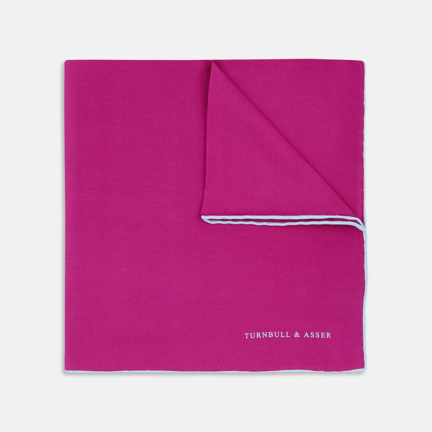 View 1 of product The Fuchsia and White Piped Silk Pocket Square by Turnbull & Asser features white edges and the brand’s name printed in white in the bottom right corner—a timeless men’s accessory.