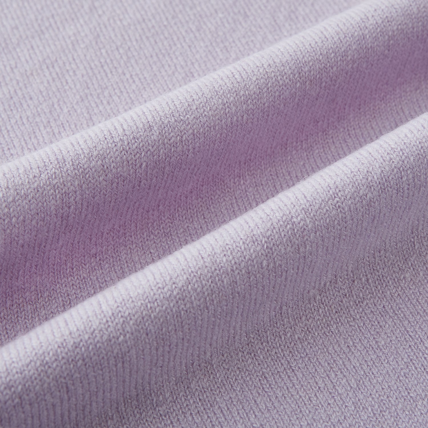 Image 3 of product The Turnbull & Asser Plain Lilac Cashmere Knitted Scarf is shown neatly tied in a loose knot against a plain white background, highlighting its elegant and timeless design.