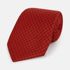 View 1 of product The Turnbull & Asser Red Lattice-Patterned Printed Silk Tie, crafted from fine English silk, is shown rolled up on a plain white background.