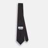 View 4 of product The Turnbull & Asser Turquoise and Forest Green Micro Dot Silk Tie is rolled up, showcasing evenly spaced micro dots on silk, displayed against a plain white background.