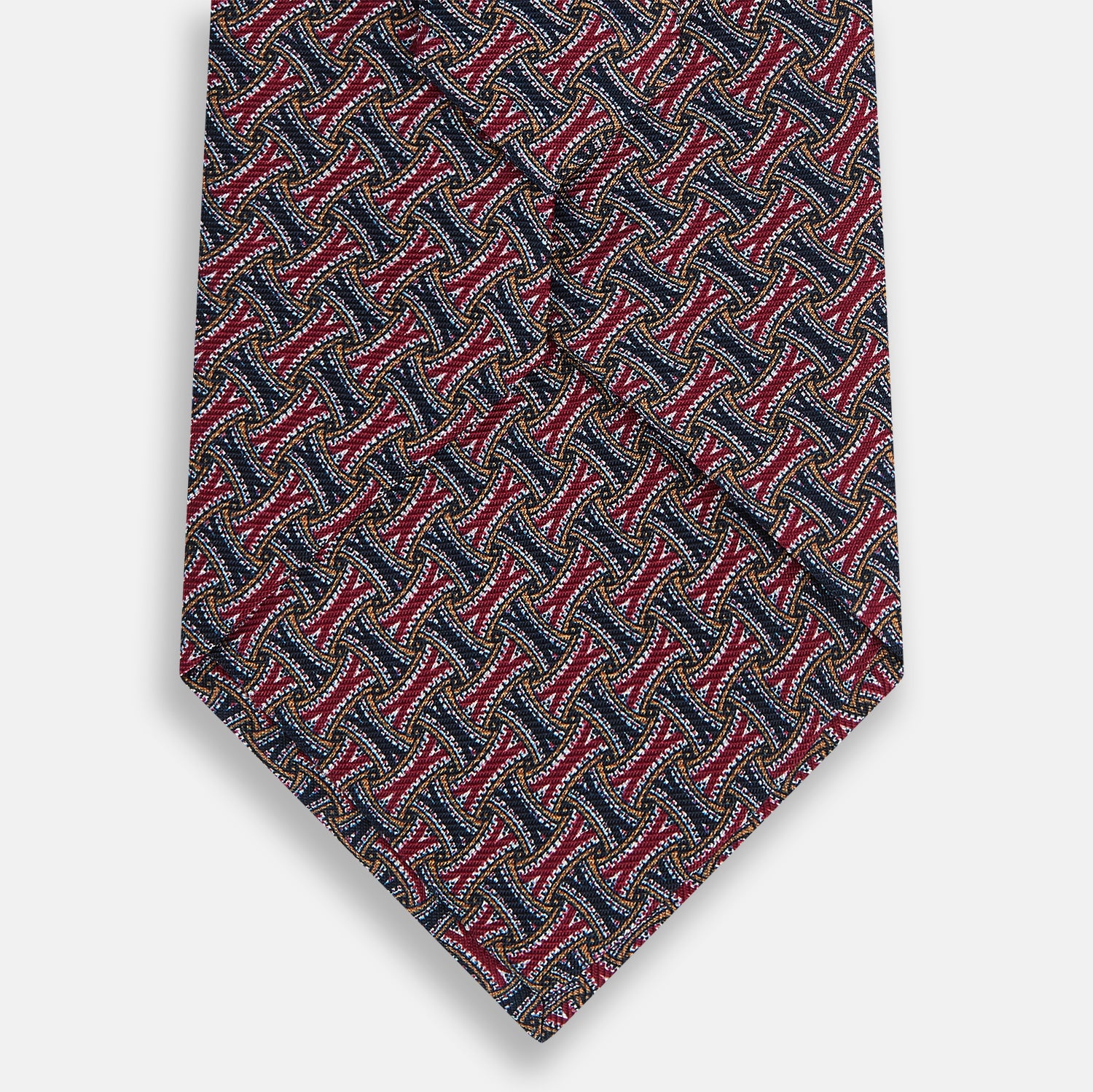 View 3 of product The Turnbull & Asser Burgundy and Navy Weave-Patterned Printed Silk Tie features an intricate geometric design, shown rolled on a plain white background.