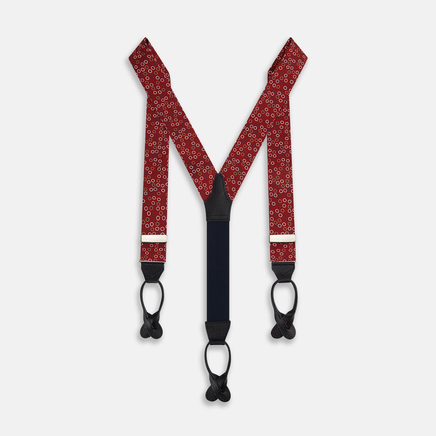 View 1 of product Pink and navy circle red adjustable silk and navy leather braces by Turnbull & Asser, arranged in an M shape on a white background—a refined choice for sartorial styling and standout men’s accessories.