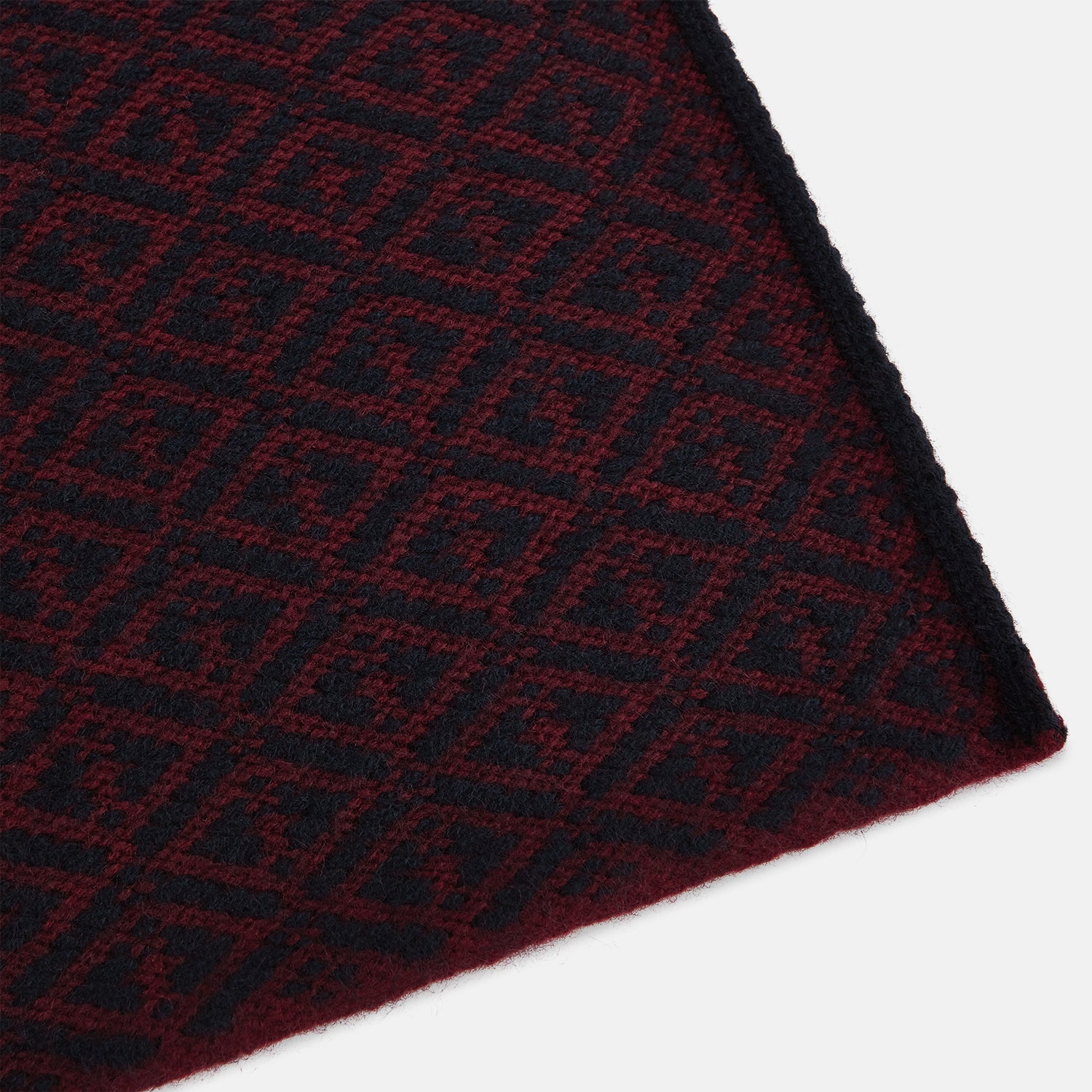 Image 2 of product The Turnbull & Asser Navy and Burgundy Diamond-Patterned Cashmere Knitted Scarf, displayed upright on a plain white background, exudes sumptuous softness.