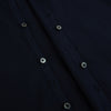 View 7 of product The NAVY BLUE WINDSOR SHIRT by Turnbull & Asser features long sleeves, a classic Windsor collar, white buttons, and buttoned cuffs—highlighting refined British craftsmanship against a plain white background.