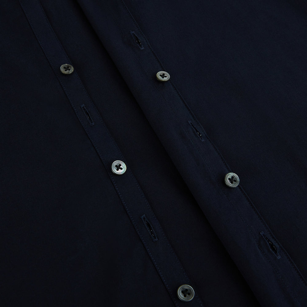 The NAVY BLUE WINDSOR SHIRT by Turnbull & Asser features long sleeves, a classic Windsor collar, white buttons, and buttoned cuffs—highlighting refined British craftsmanship against a plain white background.