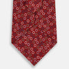 View 3 of product The Pink and Navy Circle Red Printed Silk Tie by Turnbull & Asser showcases English silk craftsmanship with a pattern of multicolored circles on rich red silk, elegantly displayed against a plain white background.