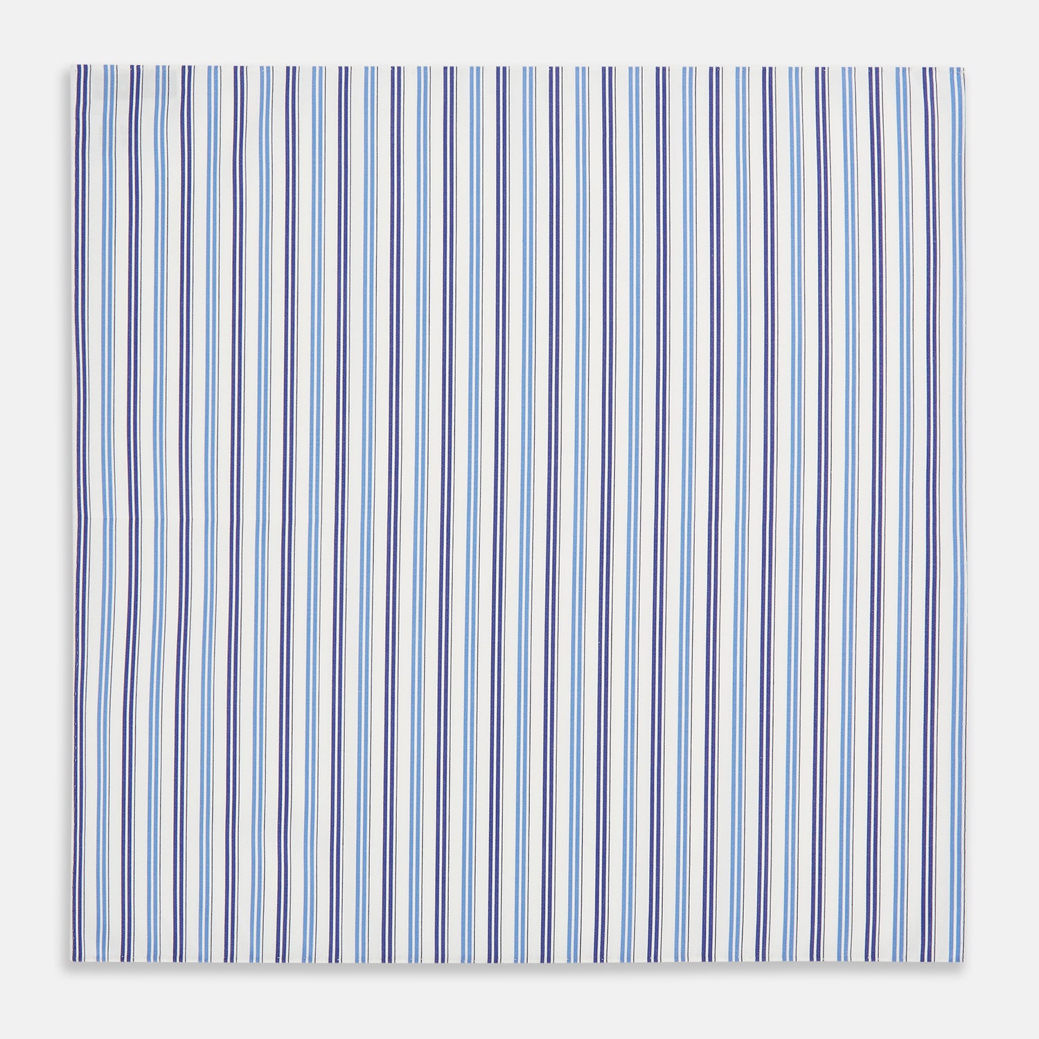 Image 3 of product The Blue and Navy Multi Stripe Hand-Rolled Handkerchief by Turnbull & Asser is crafted in England with a white background and evenly spaced vertical stripes in blue and navy.