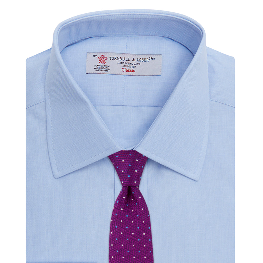 The Turnbull & Asser Light Blue End-on-End Shirt features a T&A collar and 3-button cuffs, neatly displayed against a plain white background—ideal for pairing with a navy suit.