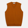 View 1 of product The Rust Ifor Slipover by Turnbull & Asser, a sleeveless V-neck in burnt orange, is made from lightweight Scottish cashmere and displayed flat on a white background.