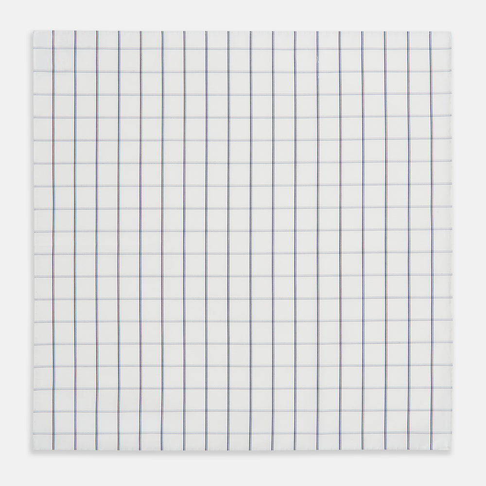 The Turnbull & Asser Dark Navy Double-Line Check Hand-Rolled Handkerchief features a white base with intersecting navy lines and hand-rolled edges, expertly crafted in England.