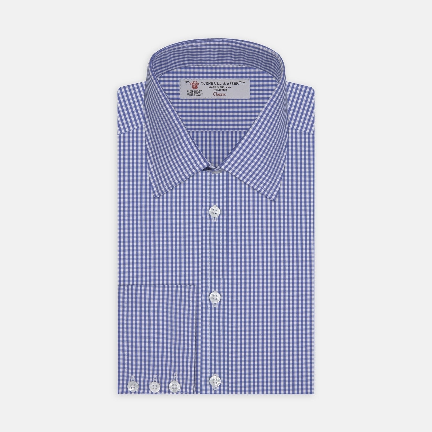 View 2 of product A circular swatch of Turnbull & Asser's Mid Blue Gingham Check Cotton Fabric, featuring a blue and white check pattern and a gray border, is shown against a plain white background.