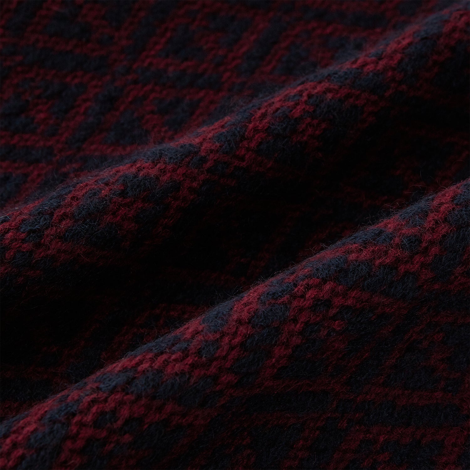 Image 3 of product The Turnbull & Asser Navy and Burgundy Diamond-Patterned Cashmere Knitted Scarf, displayed upright on a plain white background, exudes sumptuous softness.