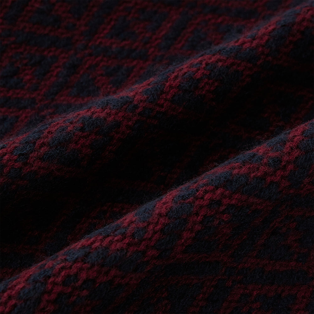 The Turnbull & Asser Navy and Burgundy Diamond-Patterned Cashmere Knitted Scarf, displayed upright on a plain white background, exudes sumptuous softness.