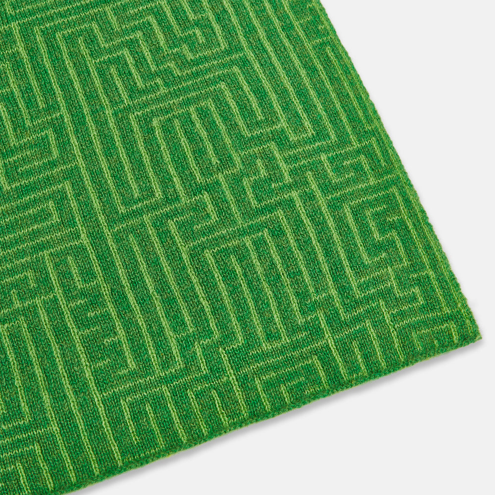 The Turnbull & Asser Kelly Green Fretwork Cashmere Knitted Scarf features a subtle, intricate pattern and is neatly knotted against a plain white background—an elegant accessory for any occasion.