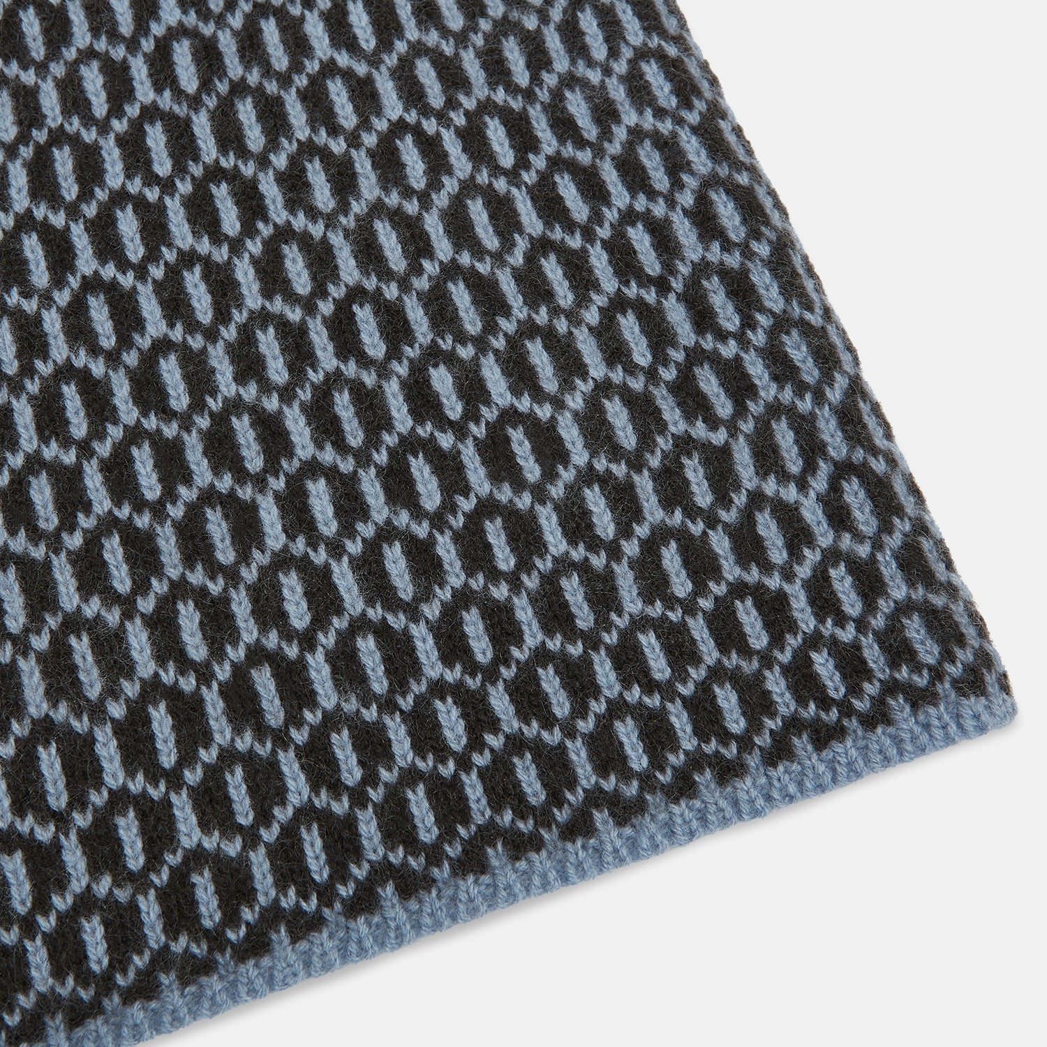 Image 2 of product The Turnbull & Asser Dark Chocolate and Pale Blue Hexagon Cashmere Knitted Scarf is elegantly looped against a white background—an essential geometric accessory for any wardrobe.