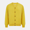 View 1 of product The Turnbull & Asser Canary Yellow Fine Merino V-Neck Cardigan features long sleeves, a button front with brown buttons, and ribbed cuffs and hem, displayed on a plain white background.