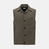 View 7 of product The Turnbull & Asser Olive Collared Linen Waistcoat is a sleeveless olive waistcoat with a collar, front buttons, one chest pocket, and two zippered side pockets, shown against a plain white background.