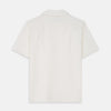 View 4 of product The Cream Silk Holiday Fit Phillips Shirt by Turnbull & Asser is a short-sleeved, collared silk shirt in off-white with three front pockets and a revere collar, displayed flat on a plain white background.