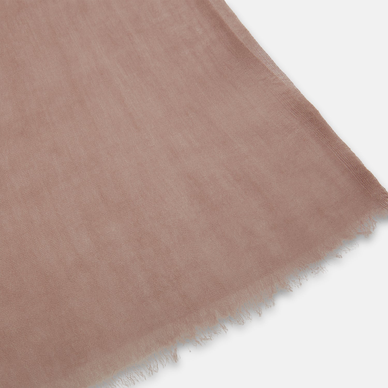 View 2 of product The Dusty Pink Cashmere by Turnbull & Asser is a long, lightweight scarf in muted mauve with frayed edges, hand-dyed and loosely folded—a luxury accessory shown on a plain white background.
