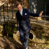 View 2 of product The Turnbull & Asser Navy Wool Pinstripe Double-Breasted Jacket features peak lapels, four front buttons, and three front pockets, and is displayed on a plain white background.