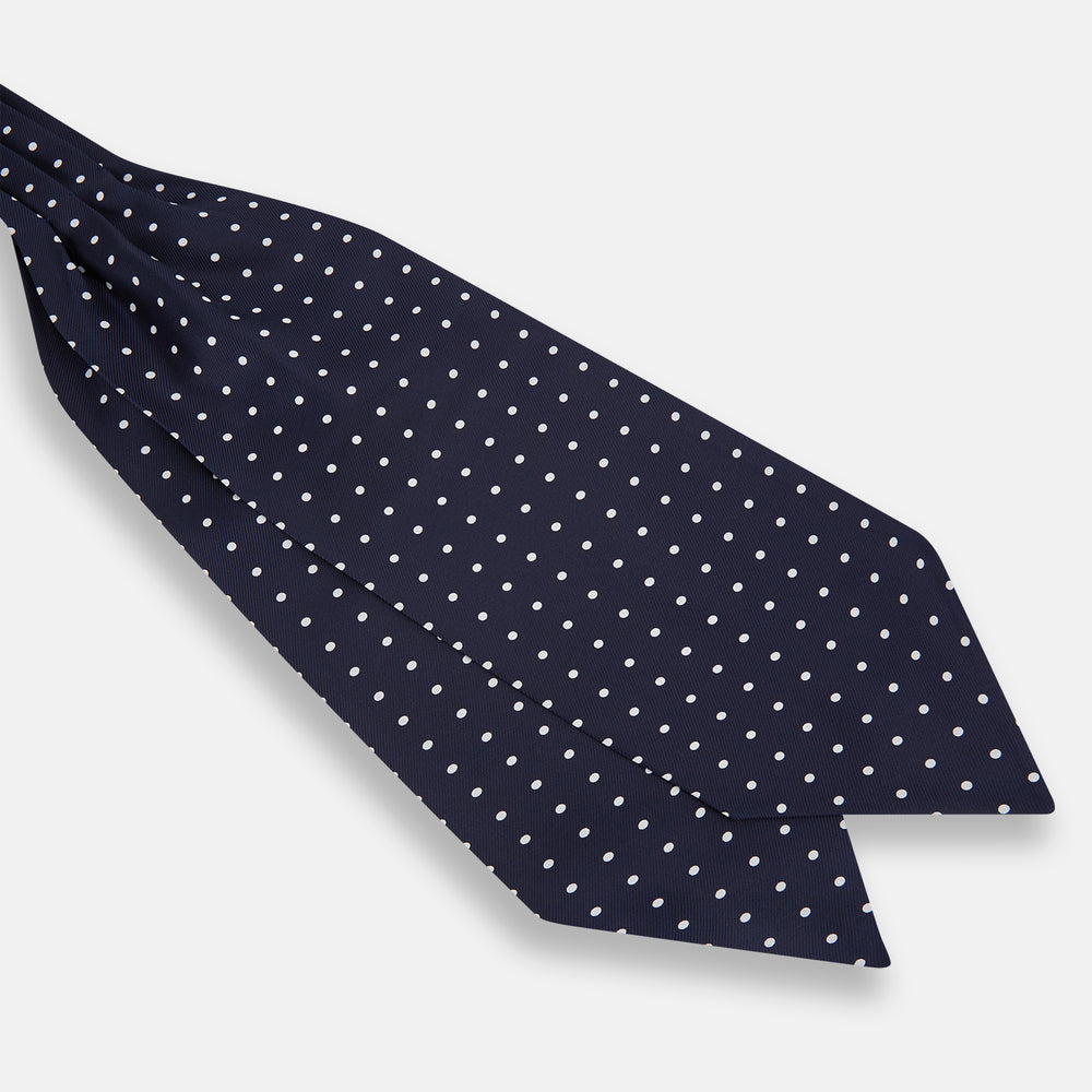 The White Dot and Navy Silk Cravat by Turnbull & Asser features evenly spaced white polka dots on navy silk—a classic accessory ideal for adding British elegance to any look.