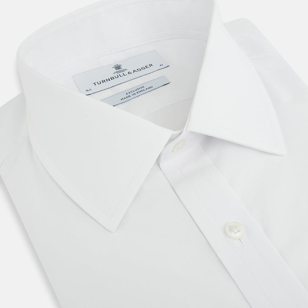 The White Mayfair Shirt by Turnbull & Asser features a classic collar, white buttons, and an inner branded label, all neatly crafted from premium sanforised cotton for lasting quality.