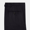 View 9 of product The Turnbull & Asser Short Navy Single Breasted Suit is shown flat on a white background, with a notch lapel jacket featuring two front pockets and matching trousers neatly folded underneath.
