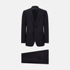 View 1 of product The Turnbull & Asser Long Navy Single Breasted Suit, shown on a white background, features a blazer with notch lapels and matching tailored trousers—ideal for formal occasions.