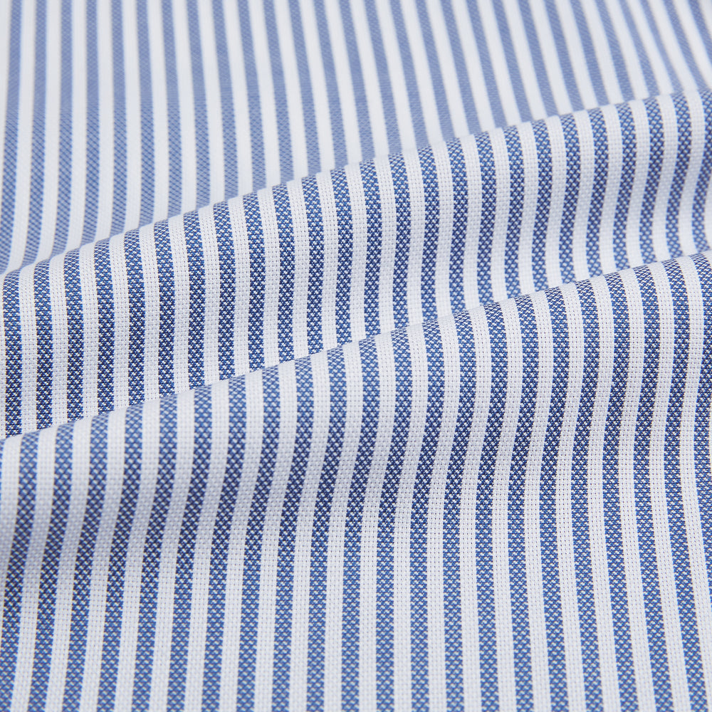 The Turnbull & Asser Navy Bengal Stripe Mayfair Shirt is a long-sleeved, collared formal shirt with blue and white stripes, white buttons, and buttoned cuffs—ideal for classic style enthusiasts. Displayed on a plain white background.