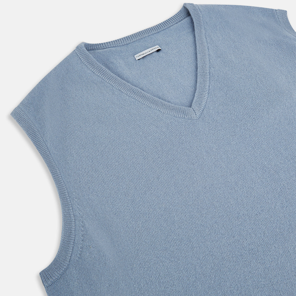 The Frost Blue Cashmere V-neck Vest by Turnbull & Asser features a sleeveless knit design and ribbed edges, shown on a white background—a sophisticated addition to gentleman’s fashion.