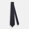 View 2 of product The Silver and Navy Micro Dot Silk Tie by Turnbull & Asser features a refined micro dot pattern, perfect for adding a classic accent to formal attire. Shown neatly rolled on a white background.