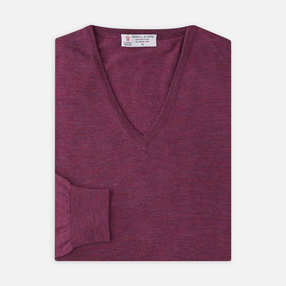 The Turnbull & Asser Plum Fine Merino V-Neck Jumper is a lightweight, long-sleeved layer in deep burgundy, featuring ribbed cuffs and hem for a refined finish, displayed against a white background.