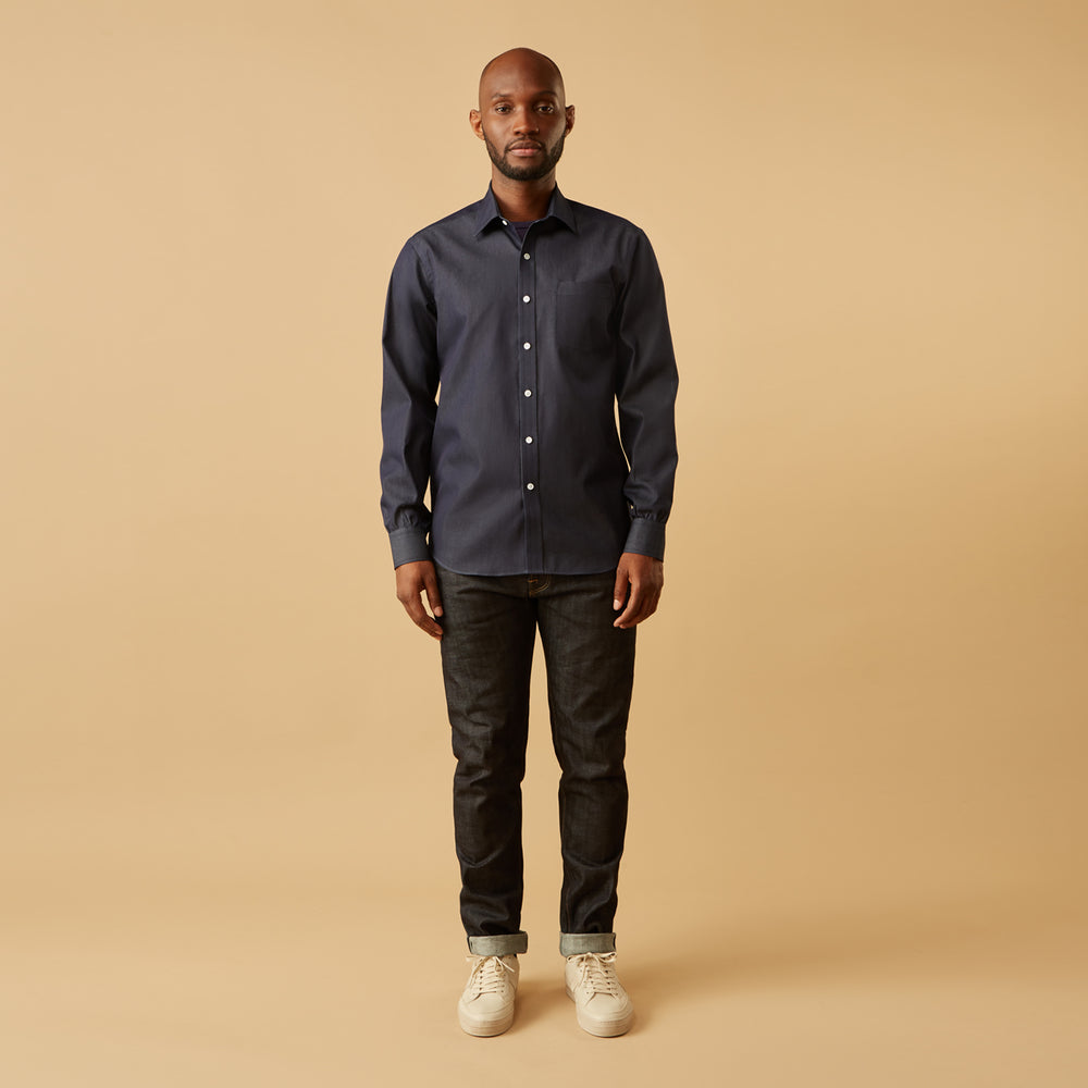 The Turnbull & Asser Blue Weekend Fit Finch Shirt features a Derby collar, chest pocket, classic white buttons, and timeless style, all in cotton. Laid flat on a white background.