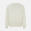 View 9 of product The Turnbull & Asser Cream Fine Merino V-Neck Jumper features long sleeves and classic styling, displayed against a white background.