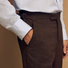 View 5 of product The Brown Puppytooth Wool Jonathan Trousers by Turnbull & Asser are straight-leg tailored trousers with belt loops, side pockets, and a front crease, shown on a white background.
