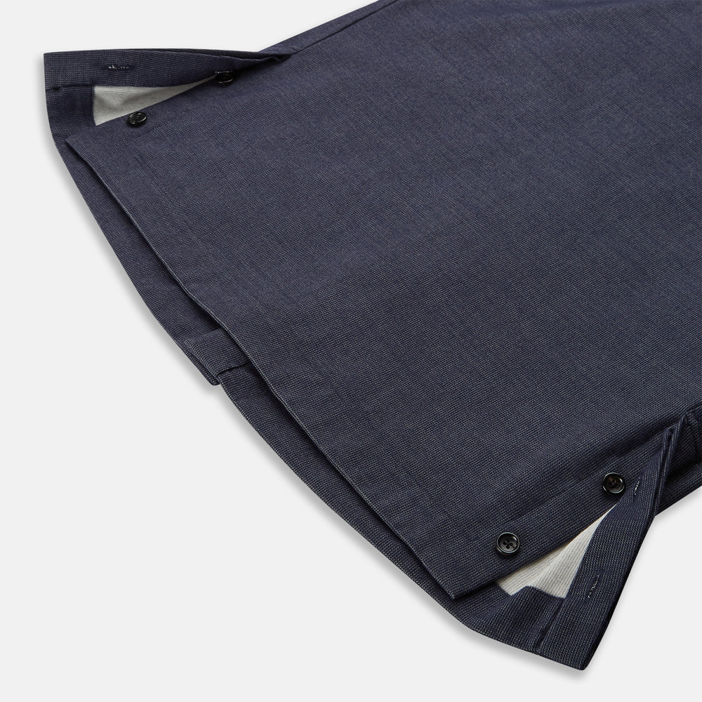 The Turnbull & Asser Navy Hampstead Overshirt features a collar, left chest pocket, two zippered pockets near the bottom, and a classic long-sleeve button-up design, shown laid flat on a white background.
