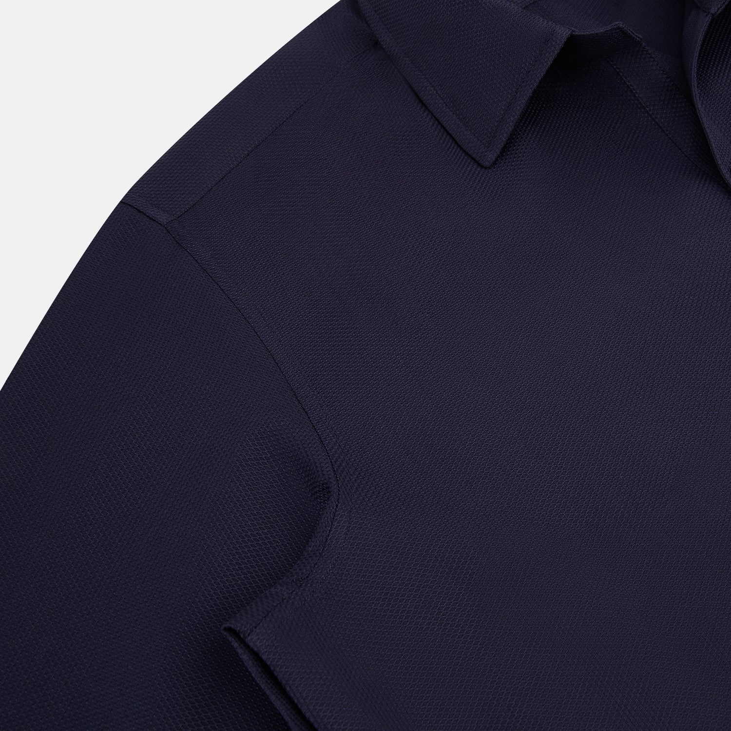 View 6 of product The Navy Textured Windsor Shirt by Turnbull & Asser features long sleeves, a Windsor collar, buttoned cuffs, and white buttons—a fine example of British craftsmanship—set against a plain white background.