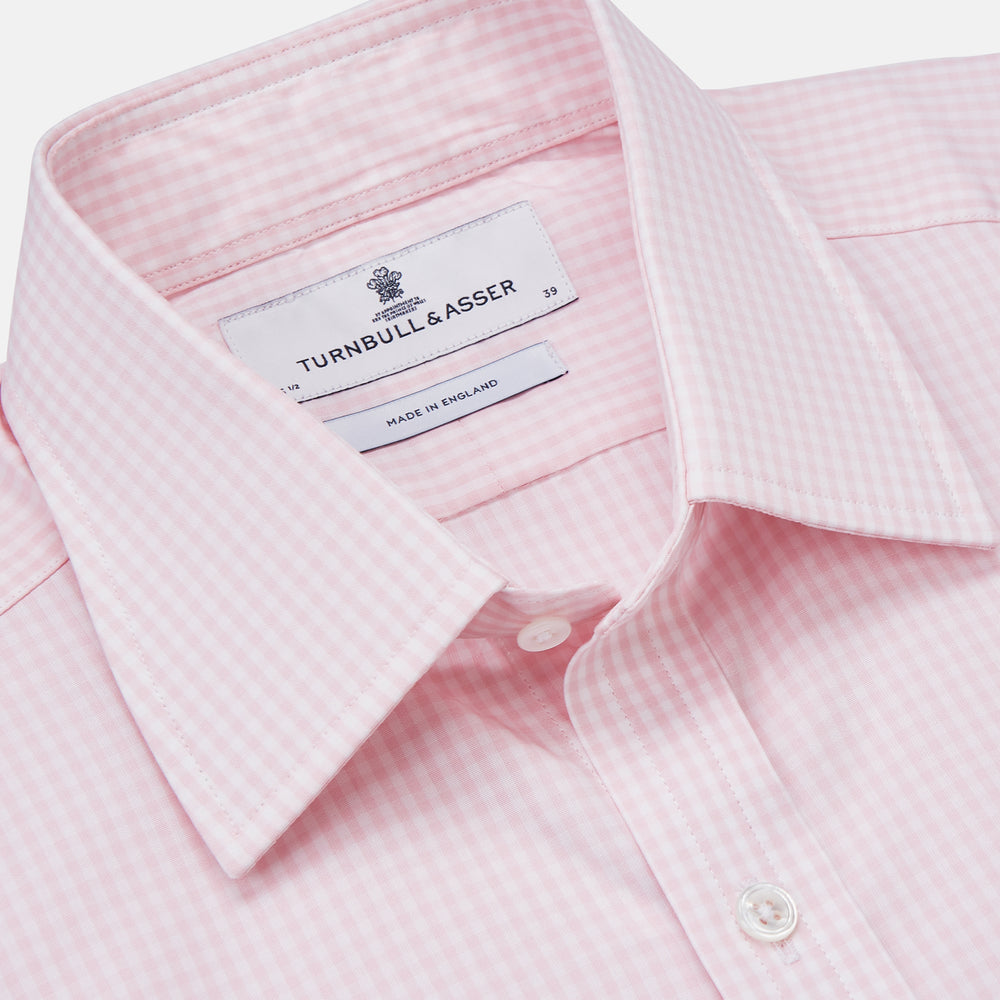 The Pink Windowpane Check Mayfair Shirt by Turnbull & Asser is crafted in light pink organic cotton with a subtle windowpane check, button-down front, and pointed collar, displayed flat on a white background.