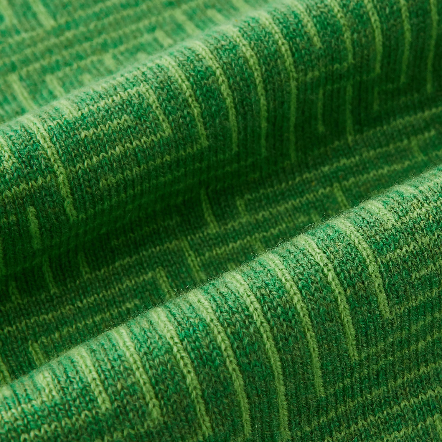 Image 3 of product The Turnbull & Asser Kelly Green Fretwork Cashmere Knitted Scarf features a subtle, intricate pattern and is neatly knotted against a plain white background—an elegant accessory for any occasion.