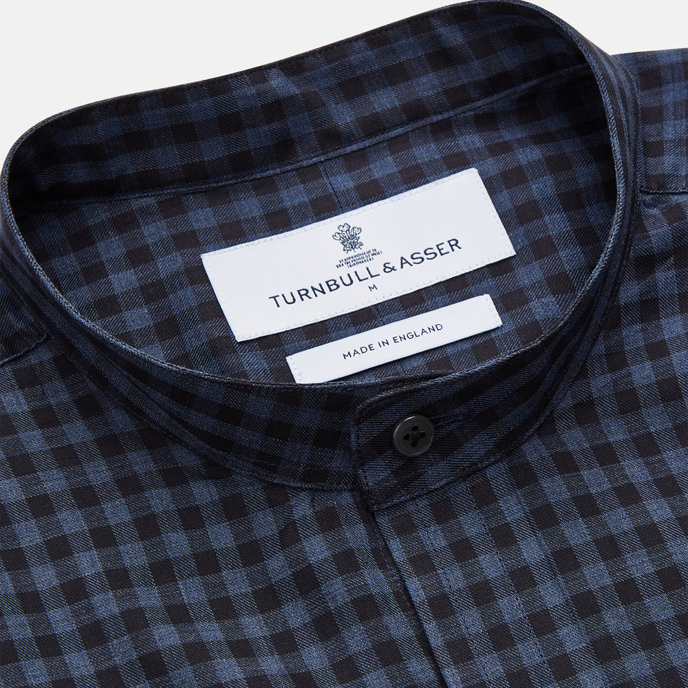 The Turnbull & Asser Navy Check Cotton Weekend Fit Blake Shirt features a long-sleeve, button-up design with a stand collar and white buttons, shown on a white background.