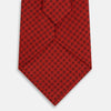 View 3 of product The Turnbull & Asser Red Lattice-Patterned Printed Silk Tie, crafted from fine English silk, is shown rolled up on a plain white background.