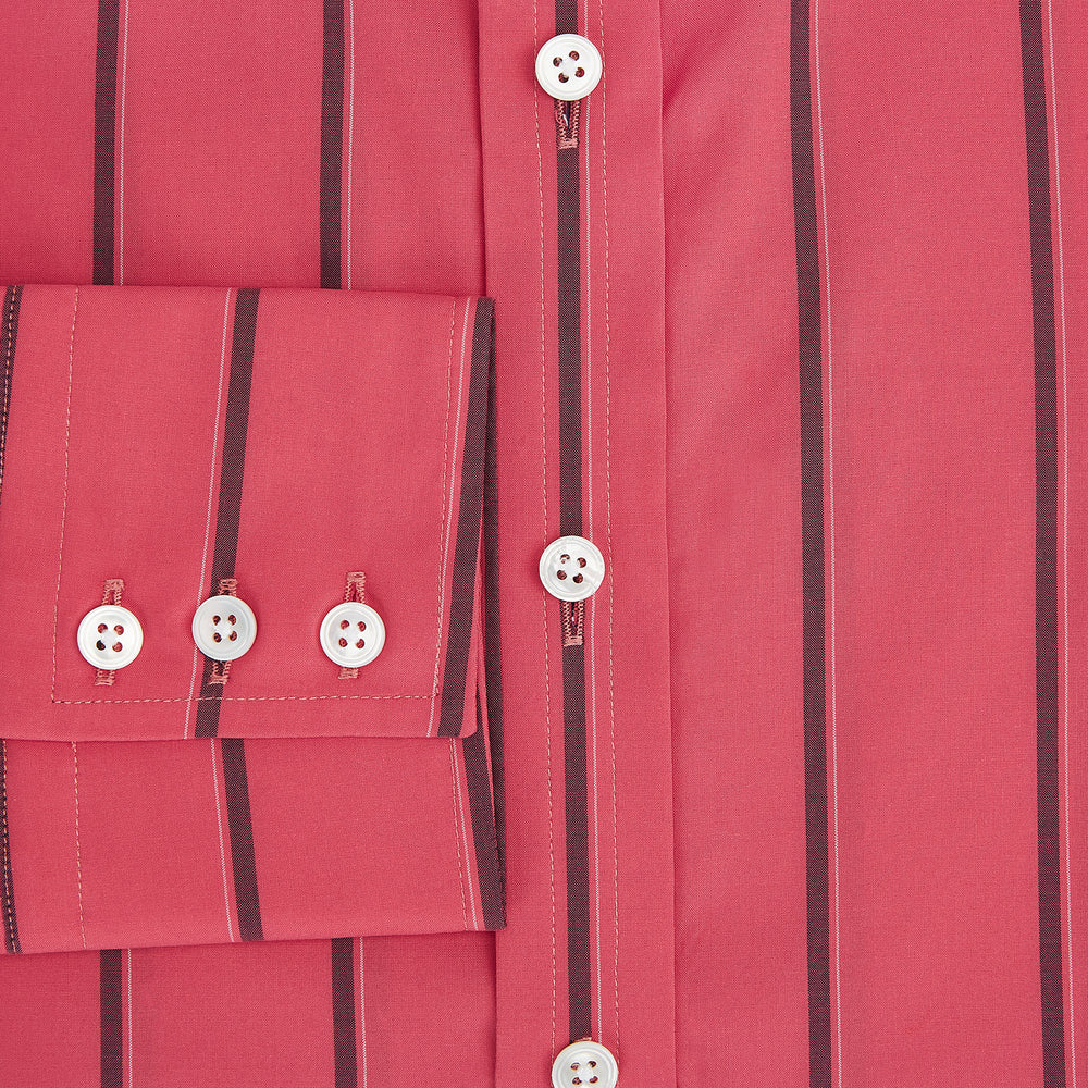The Coral Red Track Stripe Mayfair Shirt by Turnbull & Asser features long sleeves, button-up front, a classic T&A collar, and buttoned cuffs in vibrant Italian cotton with vertical black pinstripes, shown on a plain white background.