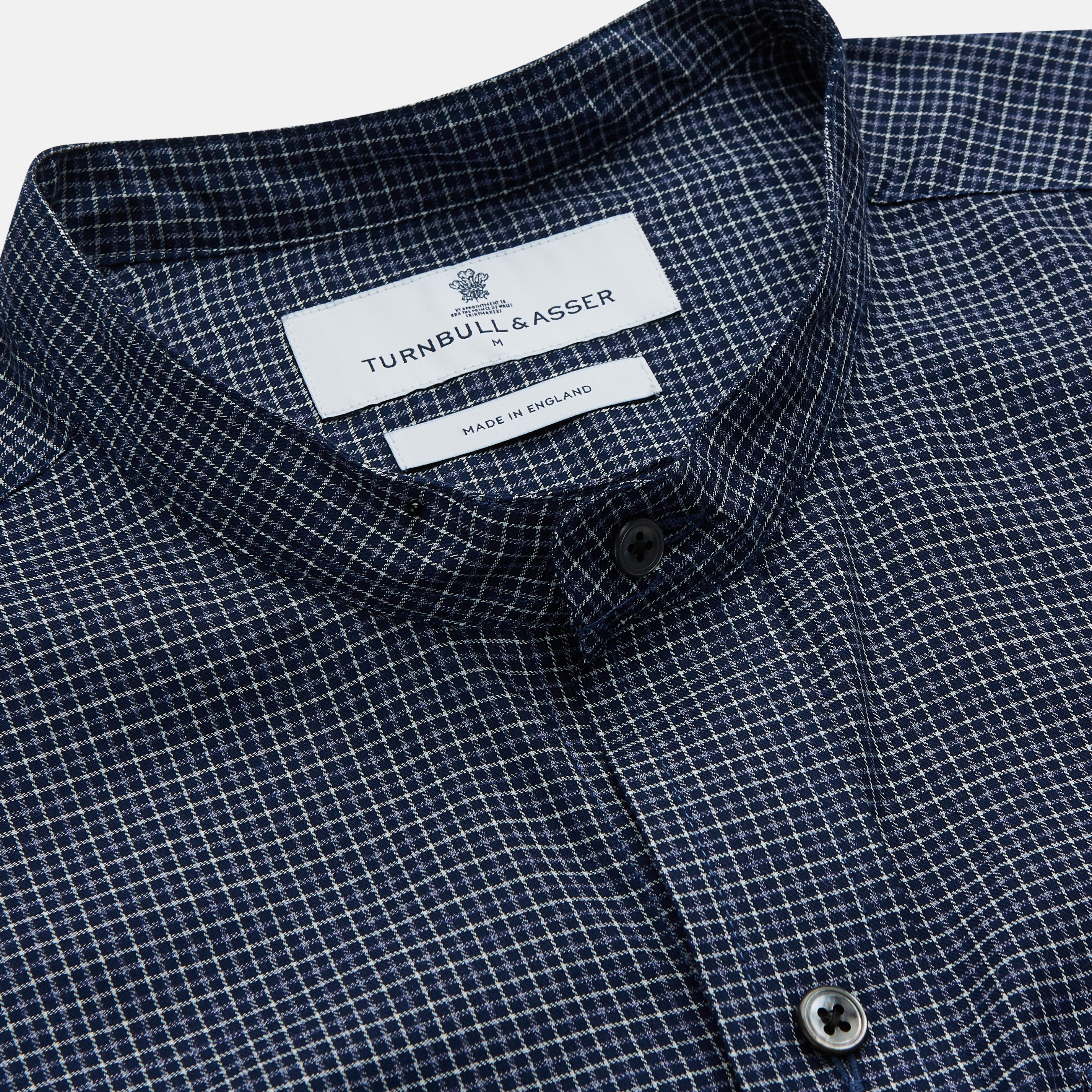 View 2 of product The Turnbull & Asser Navy Check Weekend Fit Flannel Shirt features a stand collar, button front, two chest pockets with flaps, and 1-button cuffs, crafted from soft Italian cotton and shown laid flat on a white background.