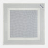 View 4 of product The Turnbull & Asser Cream Dot Silk Pocket Square features a neatly folded pure silk design with a border and center pattern of small navy blue polka dots, displayed on a plain white background.