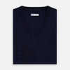 View 9 of product The Turnbull & Asser Navy Fine Merino V-Neck Jumper is displayed against a white background, featuring ribbed cuffs and hem for timeless style in a classic, plain long-sleeve design.